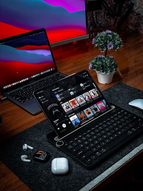 Minimalist office desk with an iMac, lamp, and stationary, perfect for tech backgrounds.